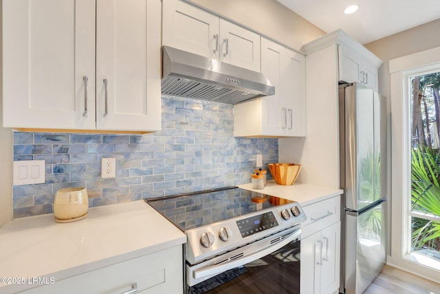 kitchen with ventilation hood, white cabinetry, decorative backsplash, and stainless steel appliances