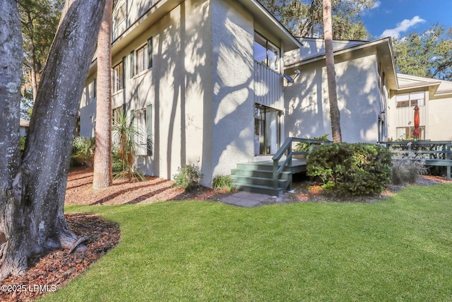 rear view of house featuring a lawn