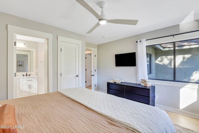 bedroom featuring sink, ceiling fan, and light wood-type flooring