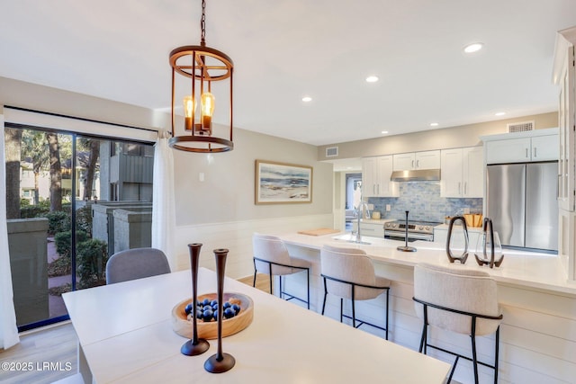 dining area featuring sink and light hardwood / wood-style floors