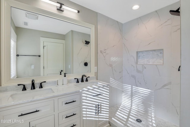 bathroom featuring vanity and a tile shower