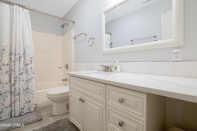 full bathroom featuring vanity, toilet, and shower / bathtub combination with curtain