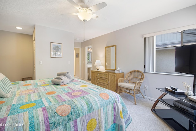 carpeted bedroom with ceiling fan and a textured ceiling