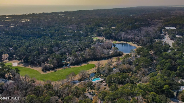 aerial view at dusk featuring a water view