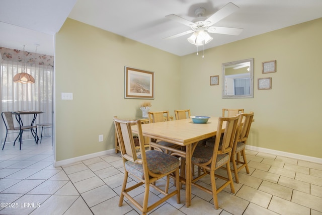 dining area with light tile patterned flooring and ceiling fan