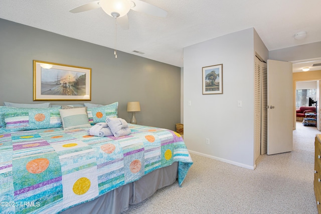 bedroom featuring ceiling fan, a textured ceiling, and a closet