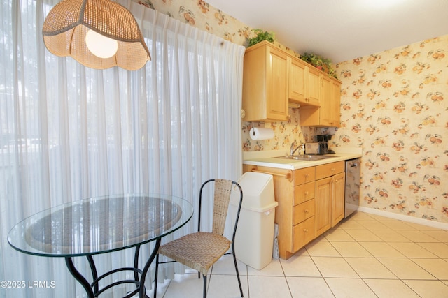 kitchen featuring light tile patterned floors, sink, dishwasher, and light brown cabinets