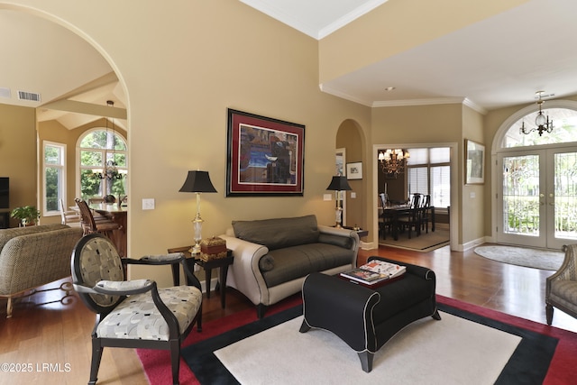 283 Seabrook Dr, Hilton Head Island, SC 29926 - living area with a chandelier, arched walkways, wood finished floors, french doors, and crown molding