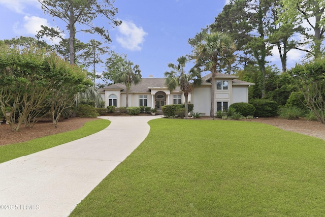 283 Seabrook Dr, Hilton Head Island, SC 29926 - view of front facade featuring concrete driveway, stucco siding, and a front yard