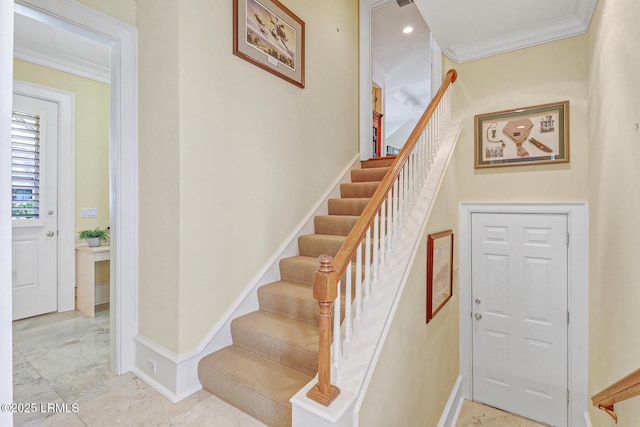 stairs featuring baseboards, marble finish floor, and crown molding