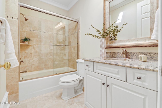 bathroom featuring toilet, ornamental molding, combined bath / shower with glass door, vanity, and tile patterned flooring