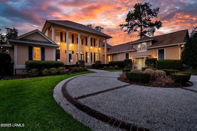 view of front of property with a front yard and stucco siding