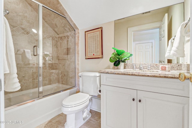 full bath featuring toilet, shower / bath combination with glass door, tile patterned flooring, and vanity