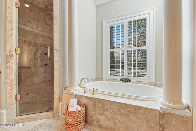 bathroom with decorative columns, a bath, and a shower stall