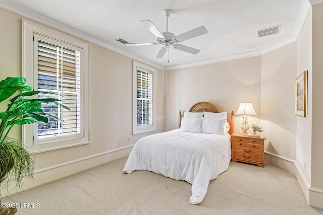 bedroom with multiple windows, visible vents, crown molding, and carpet flooring