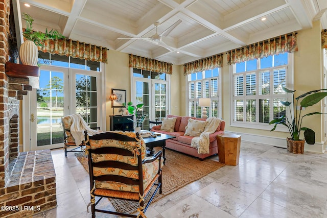 sunroom / solarium with a view of city, ceiling fan, beamed ceiling, and coffered ceiling