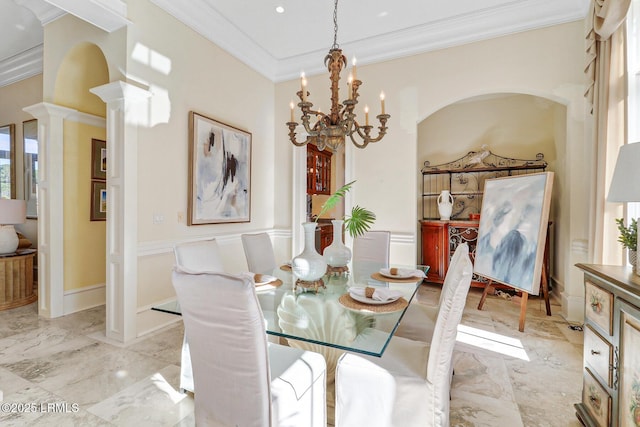 dining area with marble finish floor, a notable chandelier, decorative columns, ornamental molding, and baseboards