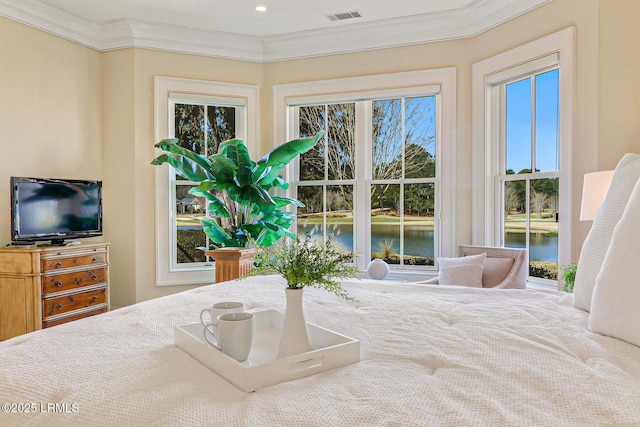 bedroom featuring a water view, visible vents, and crown molding