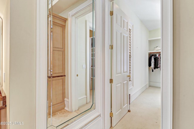 hallway with light colored carpet