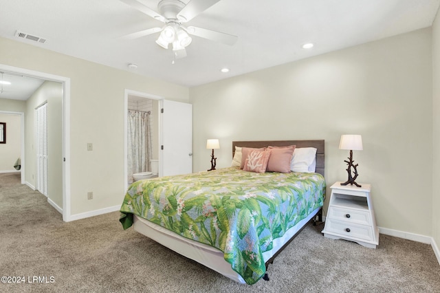 bedroom featuring light carpet, ensuite bath, and ceiling fan