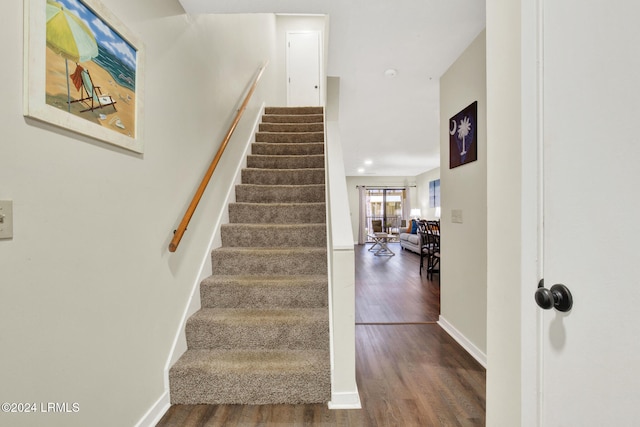 stairway with hardwood / wood-style floors