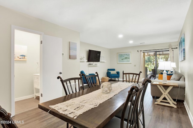 dining space with hardwood / wood-style floors