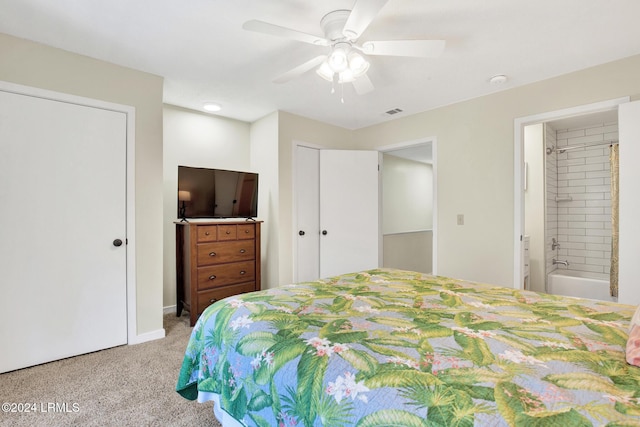 bedroom featuring ceiling fan, light carpet, and ensuite bath