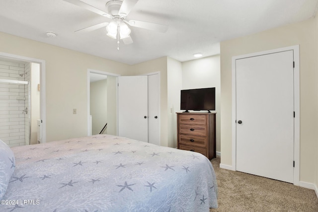 bedroom featuring light carpet, connected bathroom, and ceiling fan