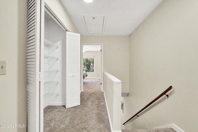 corridor featuring light colored carpet