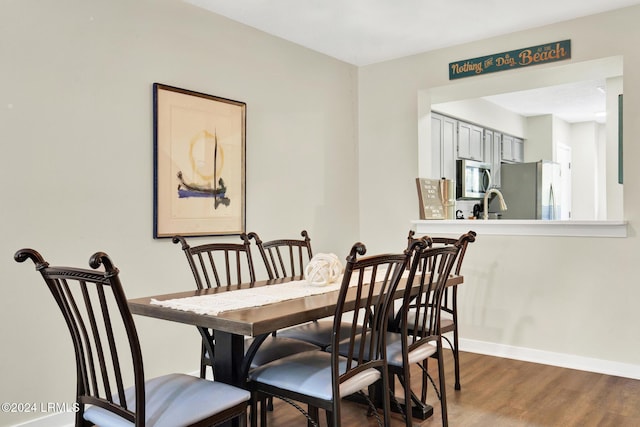 dining area with hardwood / wood-style floors