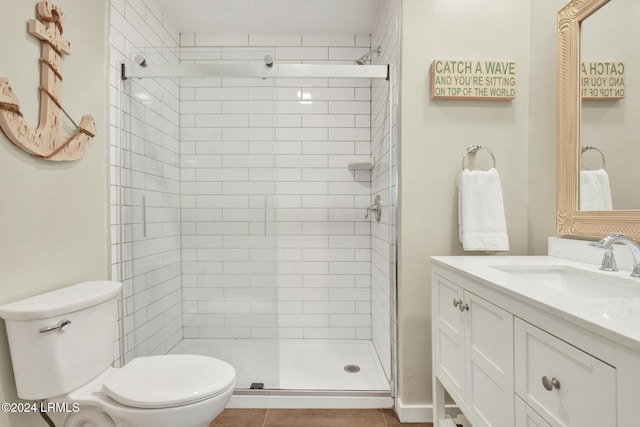 bathroom featuring vanity, toilet, and a shower with shower door