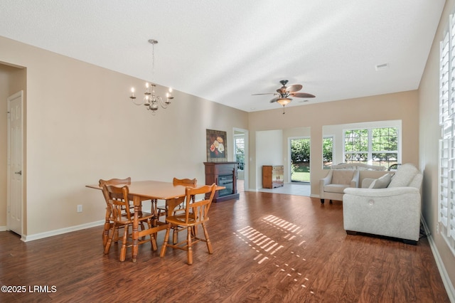 10 Cherry Ln, Okatie, SC 29909 - dining area with a glass covered fireplace, baseboards, a textured ceiling, wood finished floors, and ceiling fan with notable chandelier