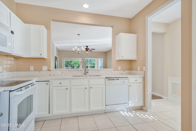10 Cherry Ln, Okatie, SC 29909 - kitchen with a sink, a chandelier, light tile patterned floors, white cabinetry, and white appliances