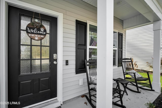 view of exterior entry with covered porch