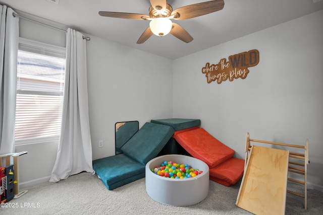 interior space with carpet flooring and a ceiling fan