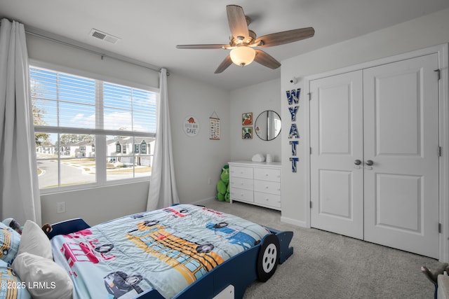 bedroom with visible vents, baseboards, carpet floors, a closet, and a ceiling fan