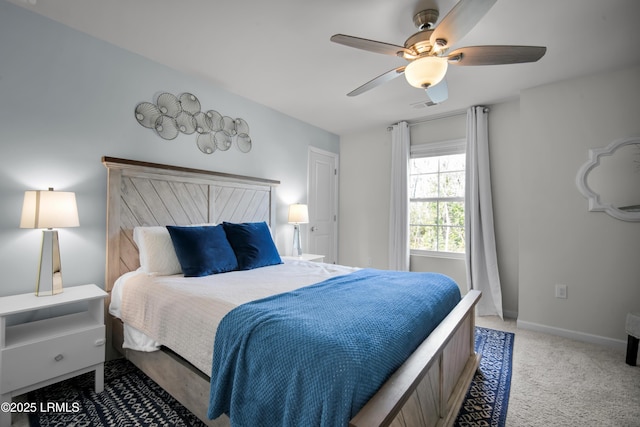 bedroom with ceiling fan, visible vents, baseboards, and light carpet