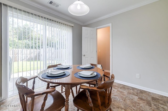 dining space featuring crown molding