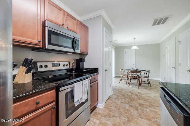 kitchen featuring dark stone countertops, decorative light fixtures, stainless steel appliances, and crown molding