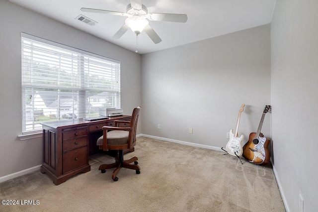 carpeted office with ceiling fan and plenty of natural light