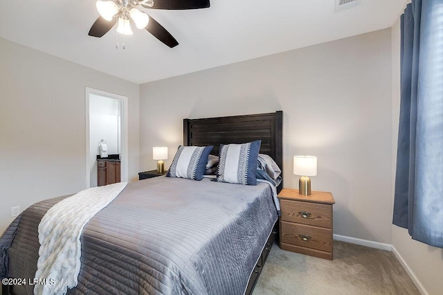 carpeted bedroom with ceiling fan and connected bathroom