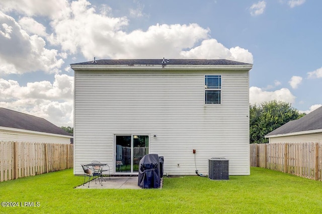 back of property featuring central AC, a patio area, and a lawn