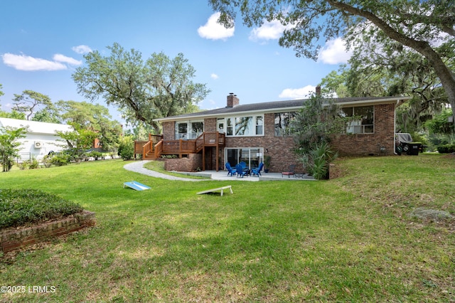 36 Stuart Town Ct, Beaufort, SC 29902 - back of property featuring a patio, a deck, brick siding, a chimney, and a lawn