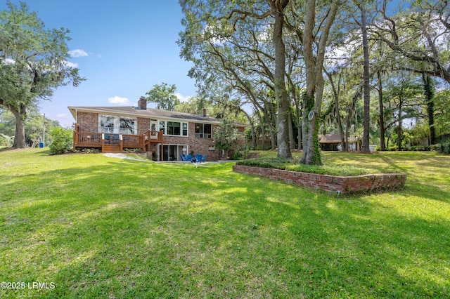 36 Stuart Town Ct, Beaufort, SC 29902 - rear view of property featuring a chimney, a wooden deck, brick siding, and a lawn