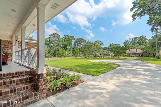 36 Stuart Town Ct, Beaufort, SC 29902 - view of green lawn with a porch