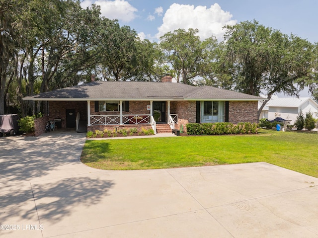 36 Stuart Town Ct, Beaufort, SC 29902 - view of front of home featuring a porch, a chimney, brick siding, a front yard, and driveway