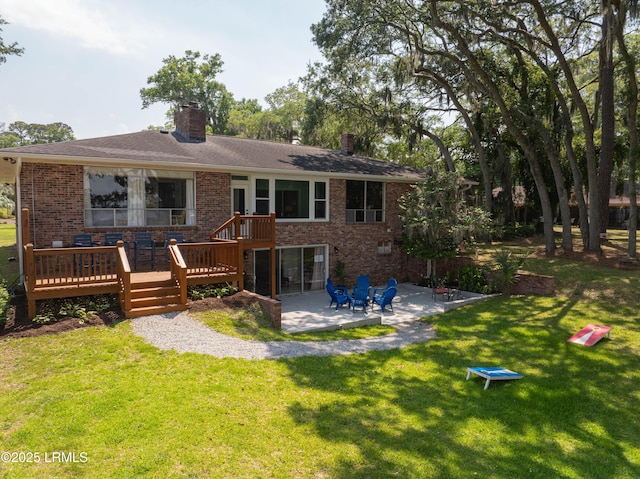 36 Stuart Town Ct, Beaufort, SC 29902 - rear view of house featuring a patio, brick siding, a deck, and a chimney