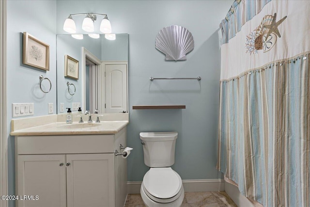 bathroom with vanity, curtained shower, and toilet