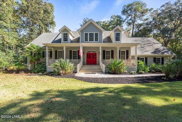 cape cod home featuring covered porch and a front lawn