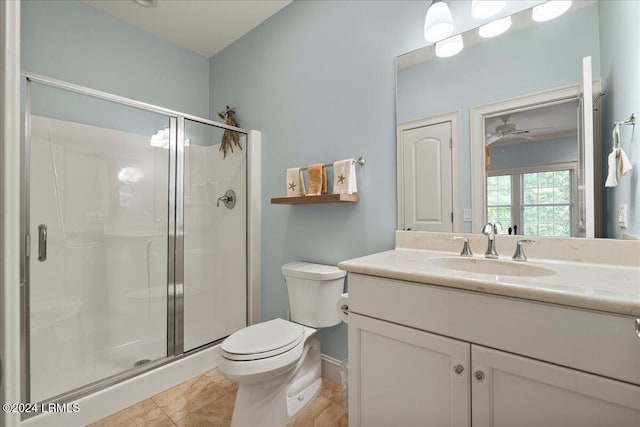 bathroom featuring vanity, tile patterned flooring, toilet, and walk in shower